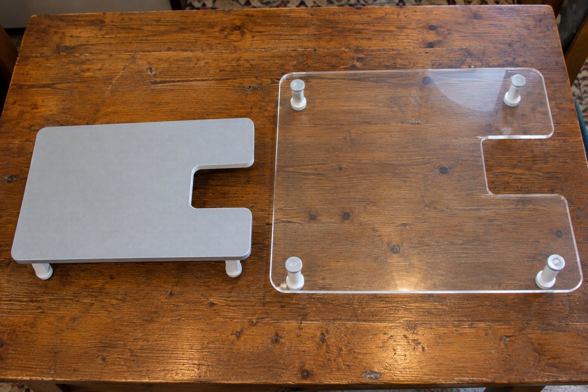 Two different sewing machine extension tables of different sizes side by side